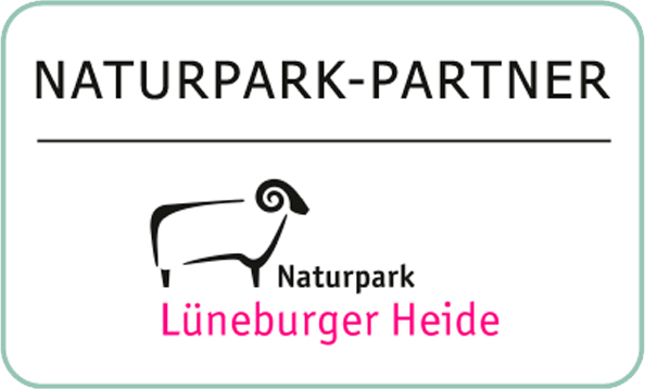 A sign featuring a sheep and text reading Nature Park Partner
